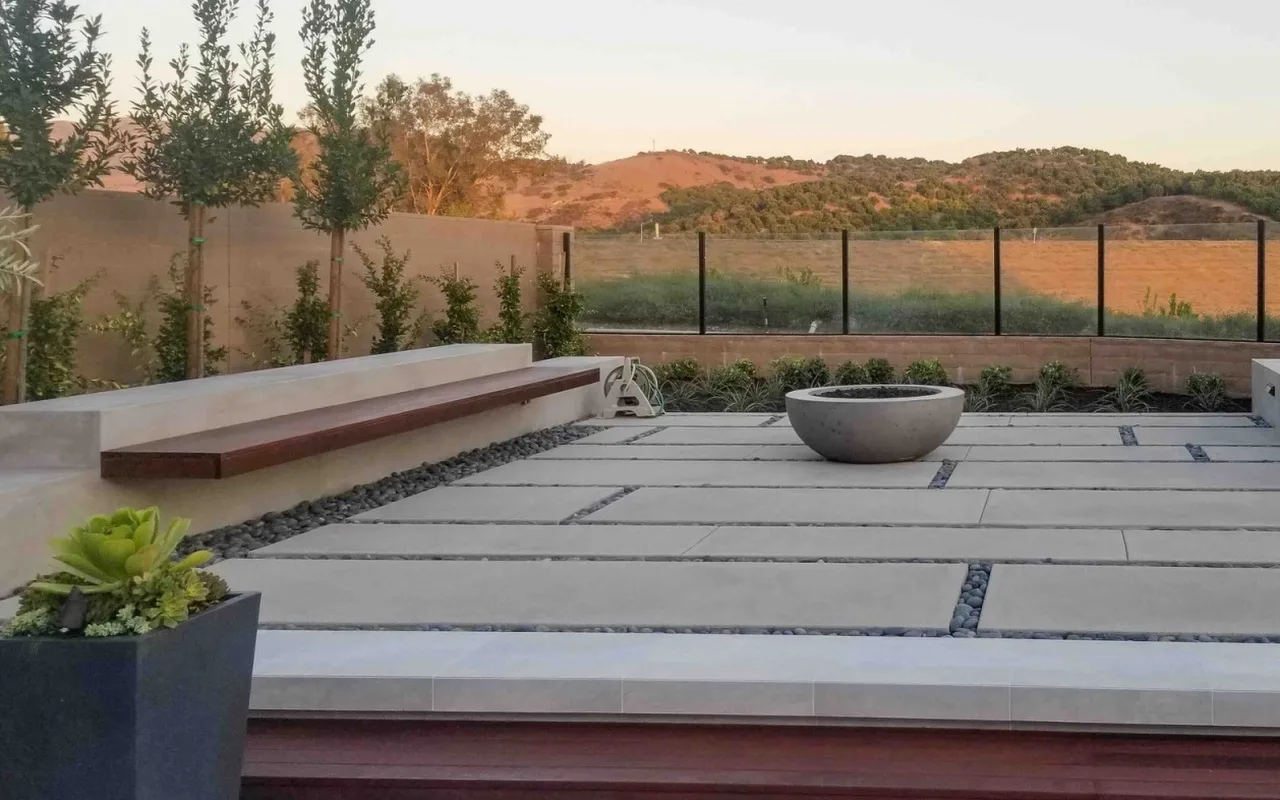 Large-format paver patio with a fire bowl and hillside views — NHG HOME project, Orange County