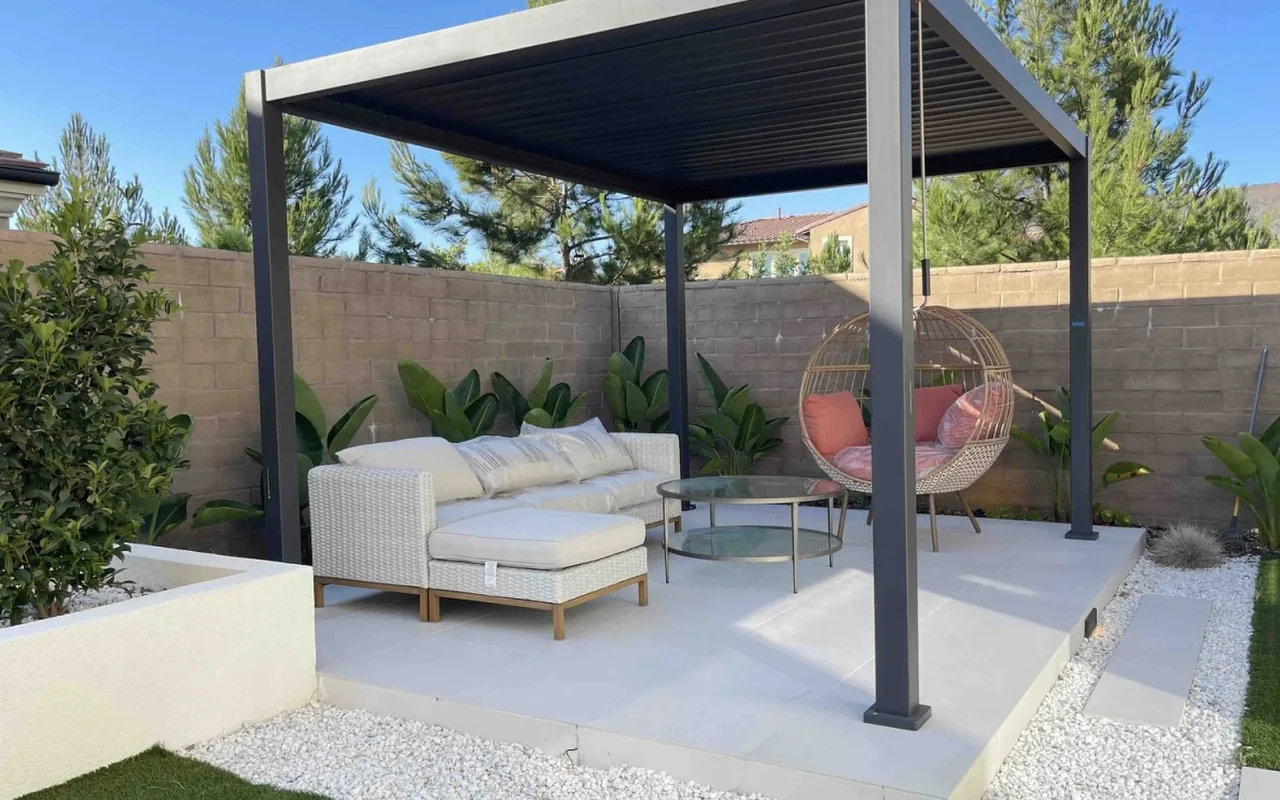 Black louvered pergola over a lounge patio — NHG HOME project, Orange County